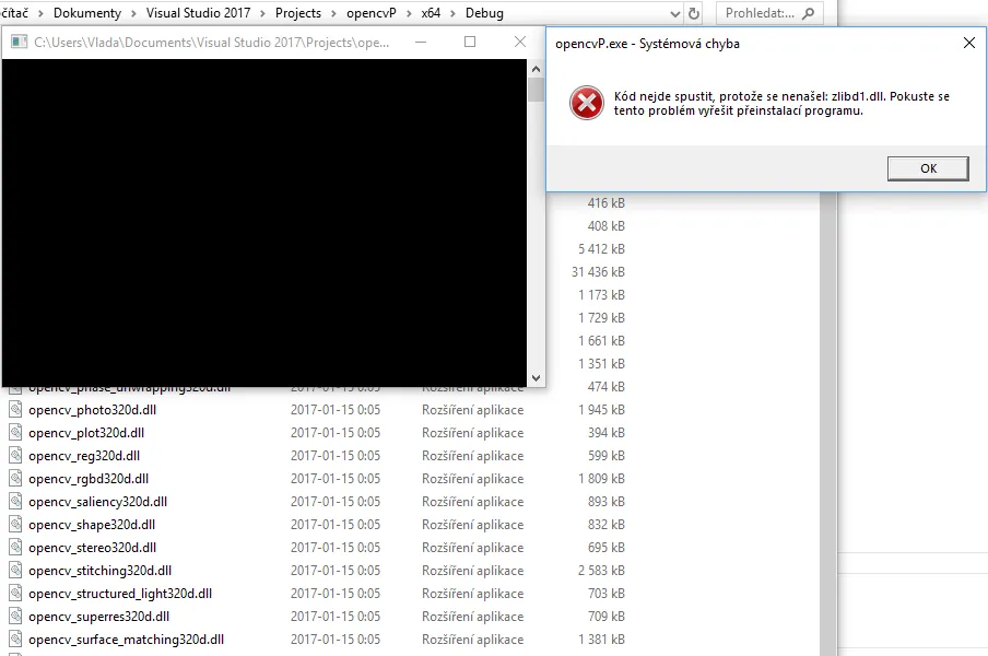 A Windows system error reporting that zlibd1.dll is missing, over the Debug folder full of opencv 320d DLLs