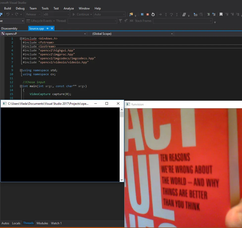 The Release build running: the source file, a console window, and a webcam frame of a book cover in the funvision window