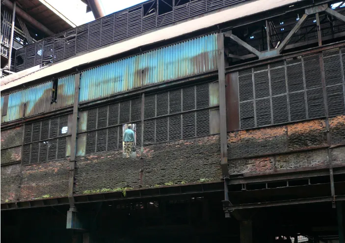 One of the training images: a worker on a walkway inside a derelict industrial hall, the kind of frame labelled for the Darknet dataset